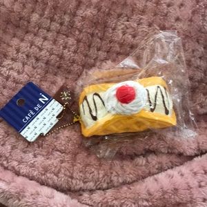 Squishy toy ice cream waffle cone taco with whipped cream/chocolate sauce/cherry